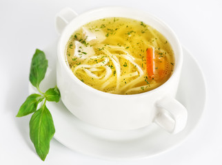 Bowl with chicken soup on white