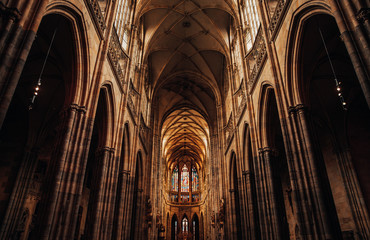 Interior of Gothic Cathedral inside. Carved pulpit, stained-glass Windows through which light rays penetrate building - obrazy, fototapety, plakaty
