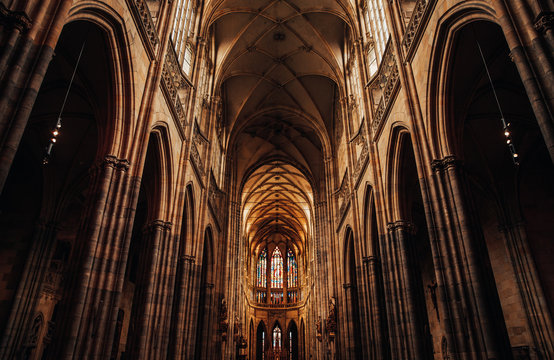 Interior of Gothic Cathedral inside. Carved pulpit, stained-glass Windows through which light rays penetrate building