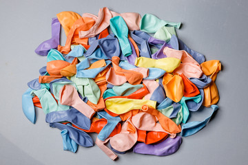 Pile of deflated color pastel balloons on a white background. Clean pure baloon template. Logo,...