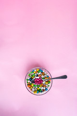 Glass bowl on pink background. bowl glass isolated. top view, copy space. Colorful candies