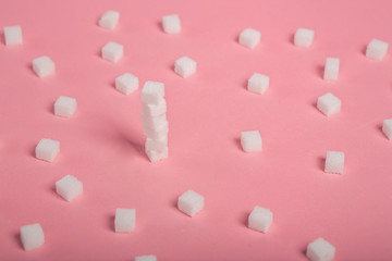sugar sweet food. Sugar cubes - unhealthy diet concept. Cubes of sugar on pink background. Empty space for copying text. Flat lay, top view, copy space.