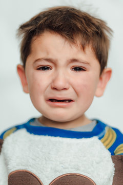 Baby crying in a studio - Image. Baby alone angry and crying. Petulant, peevish, Annoyed, Crying