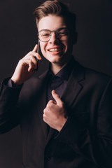 Handsome businessman speaking on mobile phone in office - Image