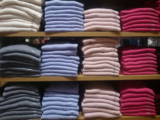 Men's multi-colored knitted shirts on store shelves