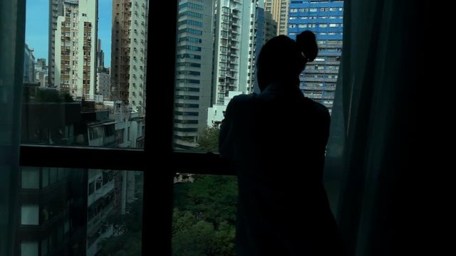 Woman admire view standing near window at home, super slow motion 120fps