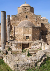 the historic church of yia Kyriaki Chrysopolitissa in paphos cyprus showing the rear of the building and old roman columns and ruins
