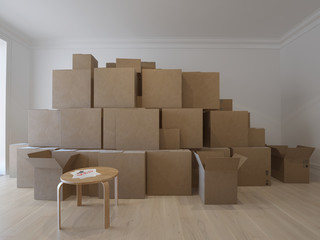 Interior with packed cardboard boxes and keys on the chair . 3d image