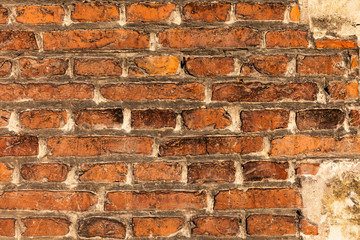 red brick wall texture grunge background with vignetted corners, may use to interior design. Old orange brick.