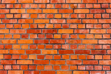 red brick wall texture grunge background with vignetted corners, may use to interior design. Old orange brick.