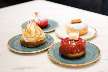 Set of dessert consist of various toppings donuts (fried cake in shape of a ball or ring) for...