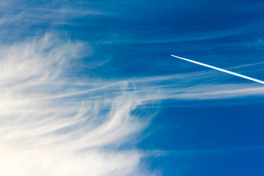 Blue Sky Background With Contrails And Clouds 