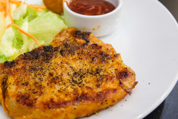 Pork steak marinated spicy and mashed potato (pig originating from English of Berkshire) with black pepper, sauce, pineapple and vegetable serve on white plate - food concept.