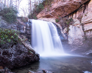 Icy waterfall in the winter season.  Long exposure waterfall in a national forest.
