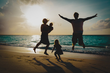 happy family with kids on enjoy vacation, play on sunset beach