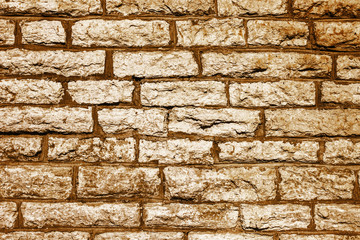 Grunge uneven wall made with brick shaped blocks. Brown industrial backdrop for graphic design.