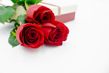 Obraz premium Flowers composition with gift box heart shaped made of rose flowers on white background. Flat lay, top view, copy space