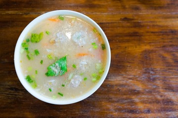 Rice Soup with pork on wooden background