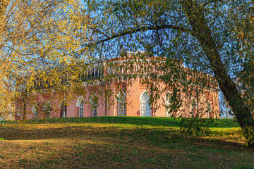 Building of Third cavalry corps on a background of trees with golden leaves at sunny autumn day in Tsaritsyno park in Moscow