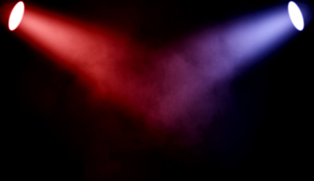 Colorful projector. Spotlight stage with smoke on black background.