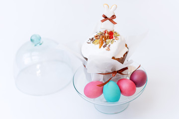 Easter cake and painted eggs. Easter composition with orthodox sweet bread, kulich and eggs on light background. Easter holidays breakfast with copy space.