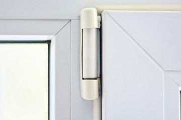 Furniture elements of white plastic window with sealant on the edge and hinge connector. Rubber...