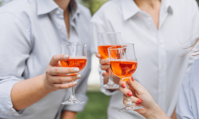 three women white shirts glasses wine hands