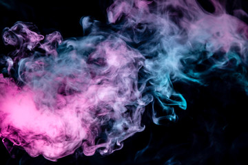 The scattering smoke on a black background smoothly flows in the neon light of pink violet and blue.