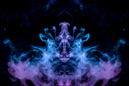 Blue flames rise up on a dark background, twisting among themselves in the image of the head of a mystical creature, evaporating smoke.