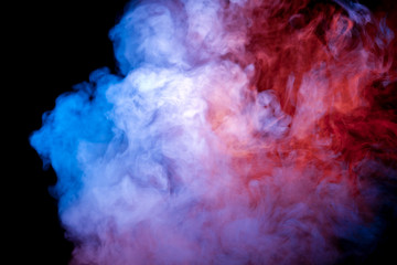 Naklejka na ściany i meble A jet of smoke soaring and exhaled from a vape evaporates in the neon light of a pink blue violet color against a dark background.