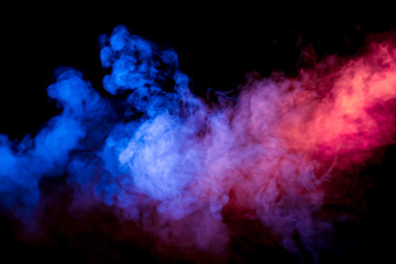 Beautiful horizontal column of smoke in the neon bright light of blue pink and orange on a black background exhaled out of the vape.