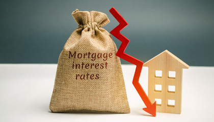 Bag with the money and the word Mortgage interest rates and arrow to down and house. Low interest...