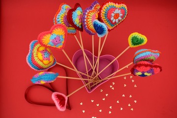 Valentine's day. Hearts on a red background. Amigurumi, handmade, knitted.