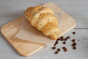 croissant on a baking paper on wooden background