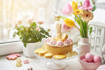 Obraz na płótnie Canvas Easter composition with sweet bread, Easter cake, eggs, bouquet of flowers. Holidays breakfast concept with copy space. Traditional easter cake with gingerbread cookies. Easter Greeting Card Template