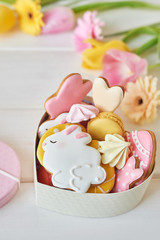 Easter greeting card with flowers, gingerbread cookies and eggs. Easter Postcard Template. Cookies in shape of eggs and Easter bunny. Happy Easter holiday background concept.