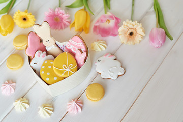 Easter greeting card with flowers, gingerbread cookies and eggs. Easter Postcard Template. Cookies in shape of eggs and Easter bunny. Happy Easter holiday background concept.