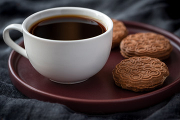 Coffee and chocolate cake. Dark background.