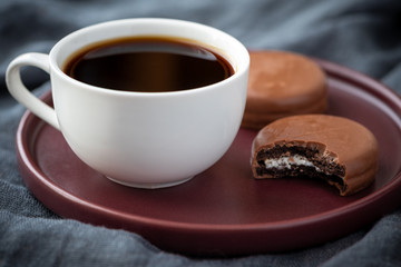 Coffee and chocolate cake. Dark background.