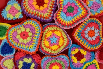 Knitted hearts of colored yarn closeup. Valentine's Day, background, design, creative.