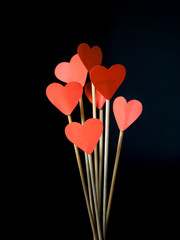 Fototapeta na wymiar Sticks with red hearts in a glass jar for Valentine's Day
