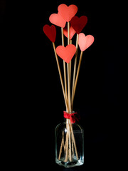 Sticks with red hearts in a glass jar for Valentine's Day