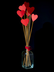 Sticks with red hearts in a glass jar for Valentine's Day