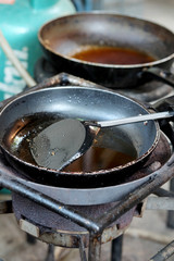 Used dirty iron pan with oil and dirty turner and space for write wording, bad cooking behavior cause of illness and health problem and financial problem to family such as cancer, digestive illness