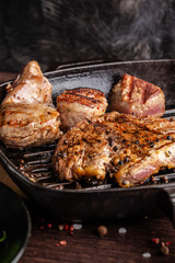 American cuisine concept. A juicy meat steak steak with black pepper is grilled on a cast-iron pan. Proper cooking of meat at home. Background image for a menu in restaurants or cafes. copy space