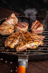 American cuisine concept. A juicy meat steak steak with black pepper is grilled on a cast-iron pan. Proper cooking of meat at home. Background image for a menu in restaurants or cafes. copy space