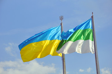 Ukraine and Rivne city flags fluttering