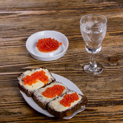 Russian tradition. A glass of vodka and a snack.Sandwiches of black bread with caviar. Caviar. 11