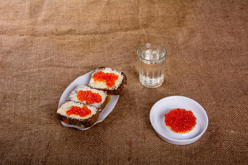 Russian tradition. A glass of vodka and a snack.Sandwiches of black bread with caviar. Caviar.  2