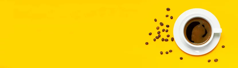 Zelfklevend Fotobehang Flat lay cup of black coffee and coffee beans on yellow background top view copy space. Minimalistic food concept, morning breakfast, time to work, hot drink, coffee background © olgaarkhipenko